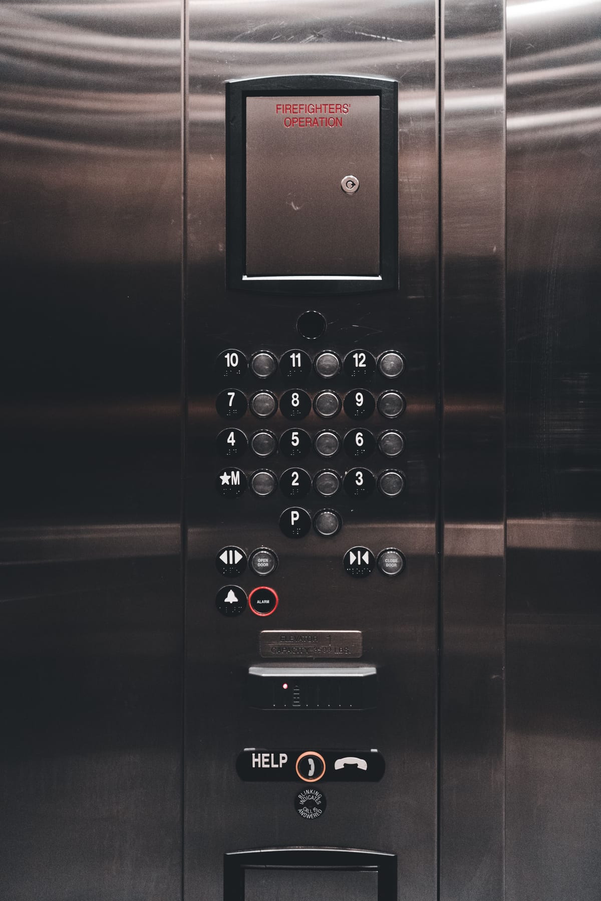 Elevator cabin panel with the HELP button that places the elevator phone call