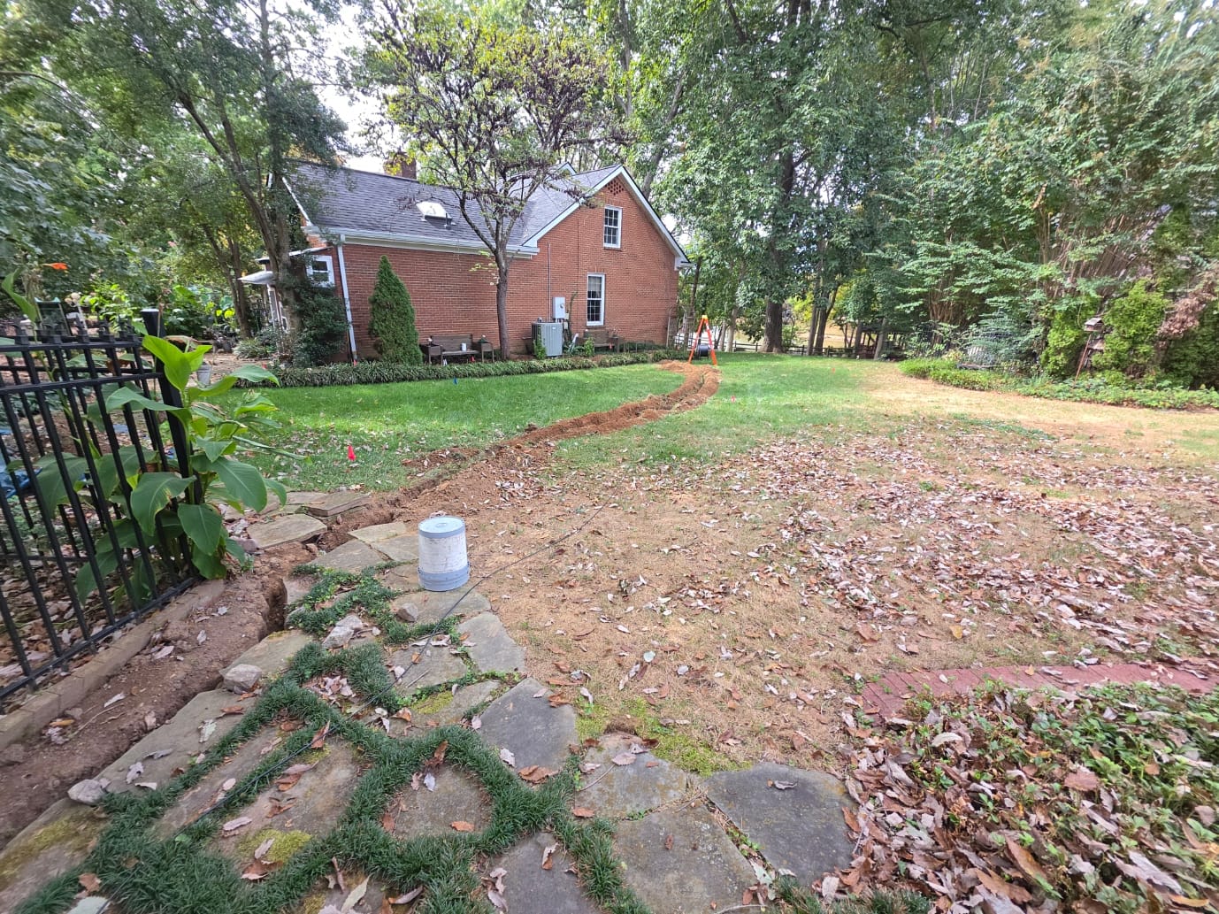 Open trench for a direct-buried single-mode fiber run between two buildings at a home-based business in Nashville, TN